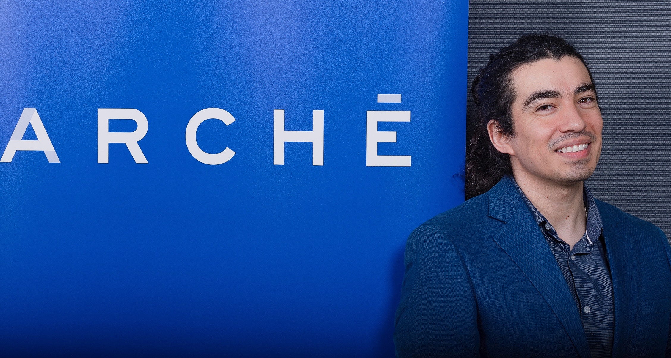 Abel Quintero in front of Arche banner