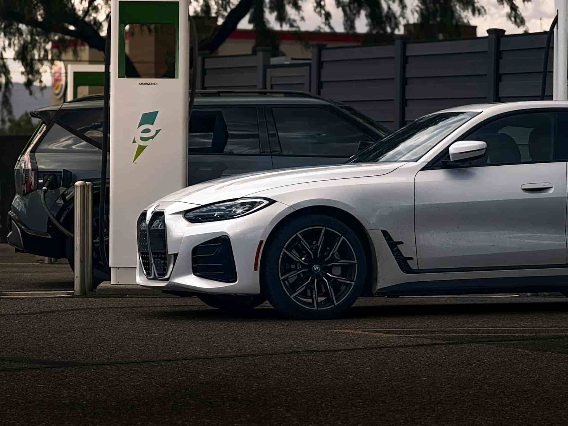 A picture of a BMW at an EV network for charging process.