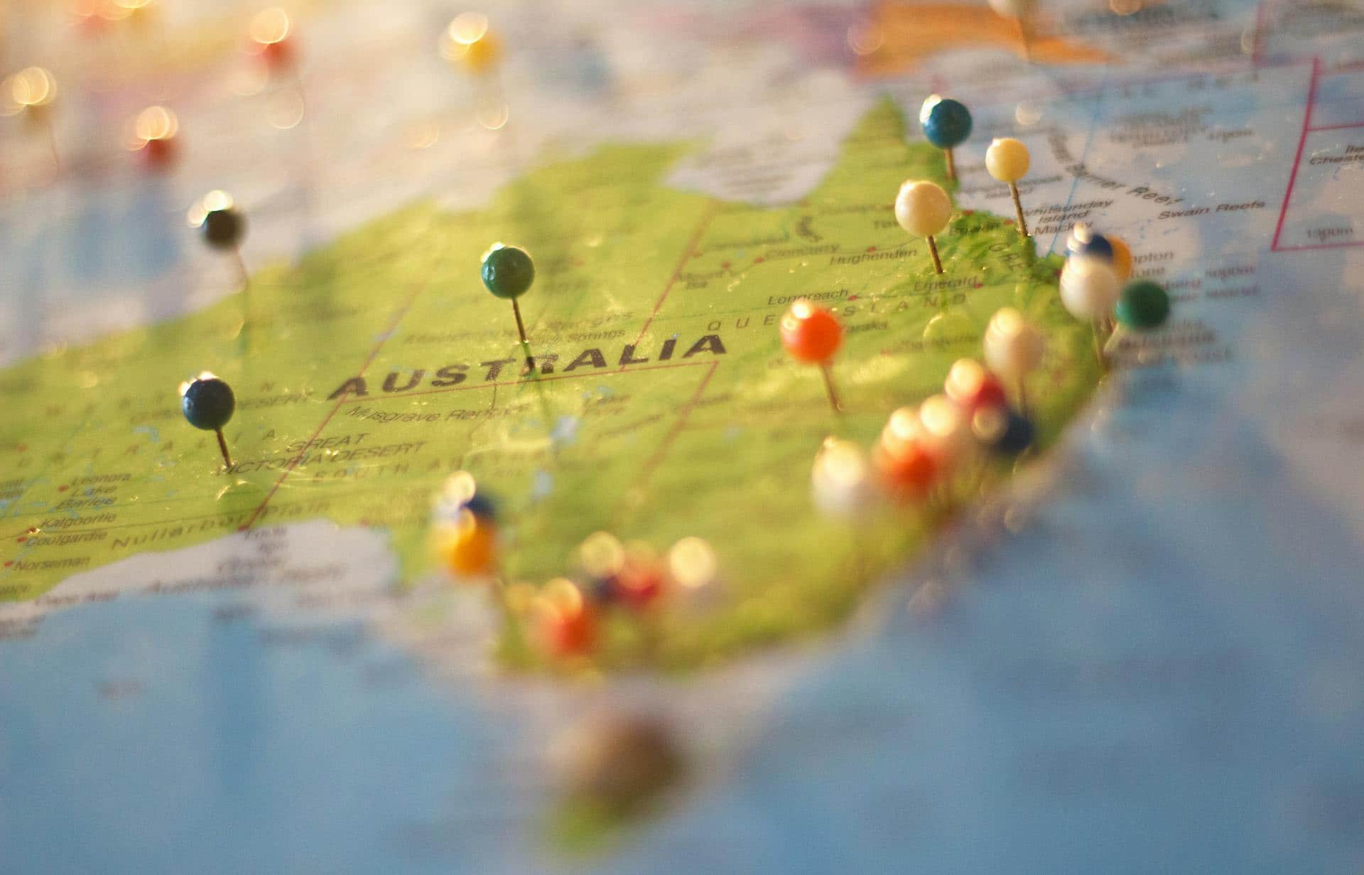 A picture of Australia with tacks on it to symbolise this article that discusses about GIS and advanced data analytics.